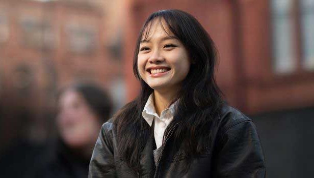 Student smiling into the distance