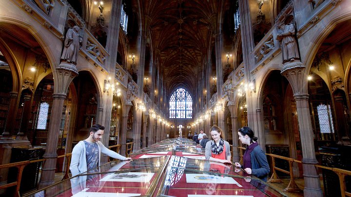 Students looking at publications in John Rylands Library