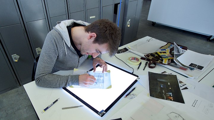 Student drawing architecture designs
