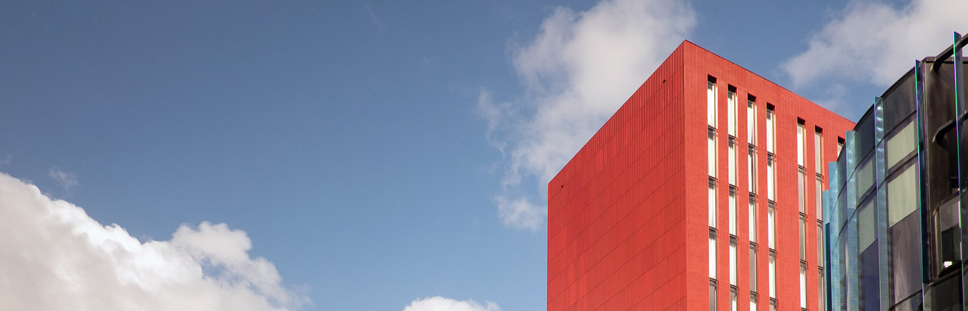 Red building against blue sky, Manchester