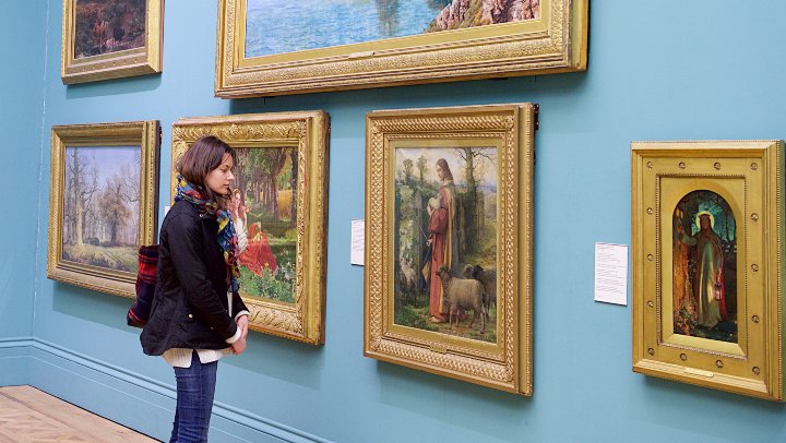 Student looking at artwork in a gallery