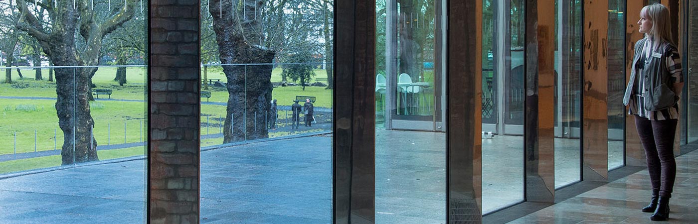 Young woman in the Whitworth extension looking out of the window