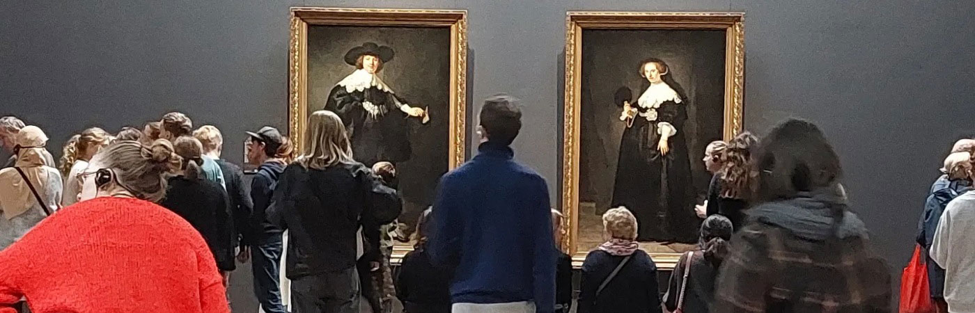 People looking at paintings in a gallery