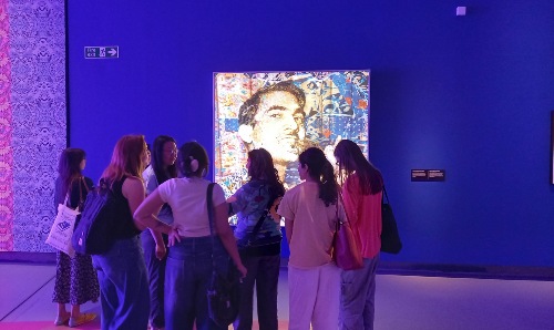 Artist Chila Kumari Burman and students discuss her exhibition 'Chila Welcomes You', Imperial War Museum North, May 2025.