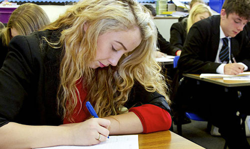 Secondary schoolchildren working in a classroom.