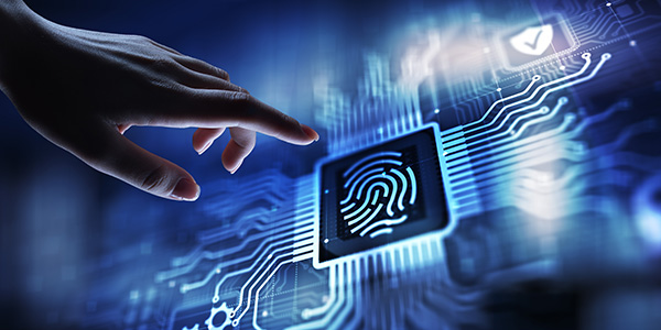 Hand reaching toward digital fingerprint scanner on microchip, symbolising cybersecurity protection.