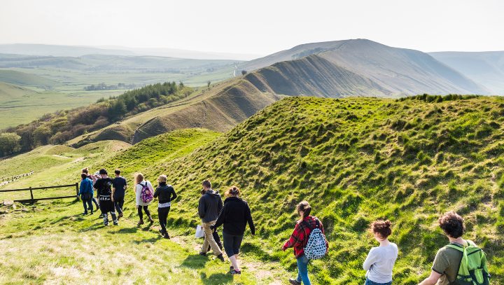 Line of students walking on a hilly path