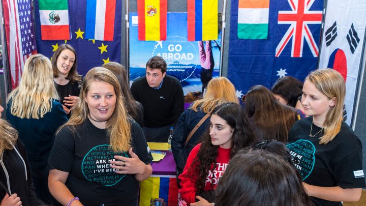 Group of students stood at an open day stand