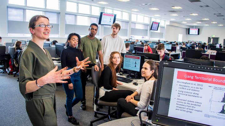 Criminology students are talking with a lecturer.