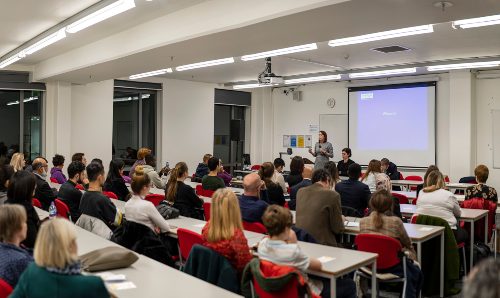 Claire McGourlay talking to a room of people at the Justice Hub opening. 