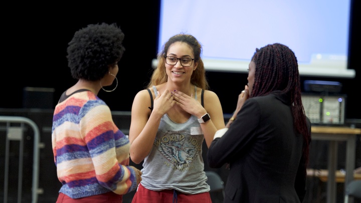 Students chatting in a drama theatre