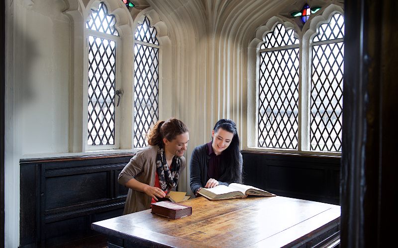 Two students looking at a textbooks