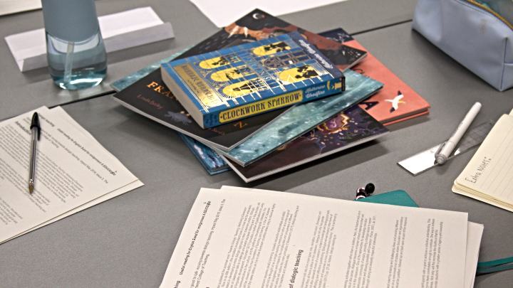 Books and stationary laid out on a desk