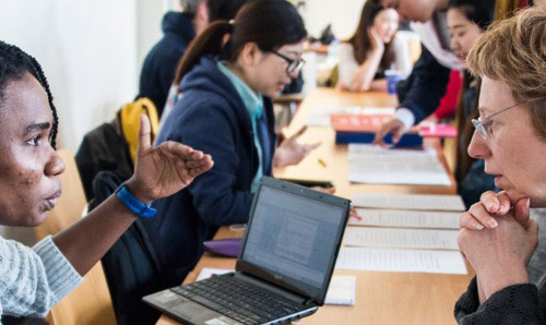 Education lecturer speaking to a student.
