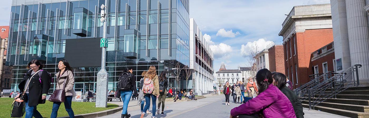 Students walking around campus near the Alan Gilbert Learning Commons building.