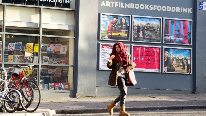 Student walking across the road in Manchester