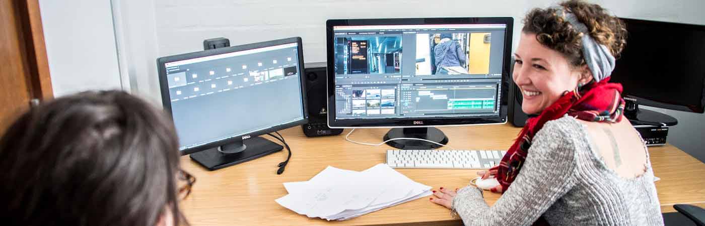 Two students in media editing suite