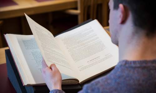 Student with book from Special Collections.