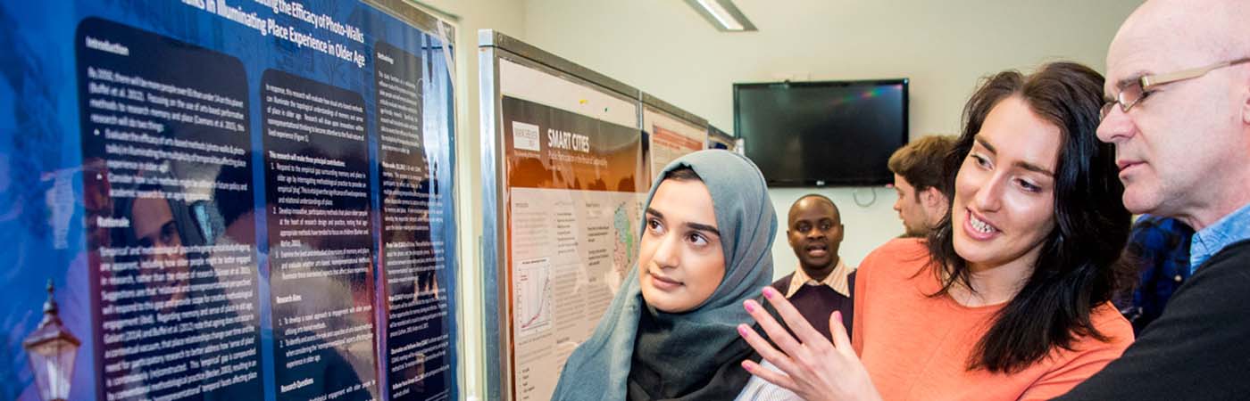 Students collaborating at geography poster event
