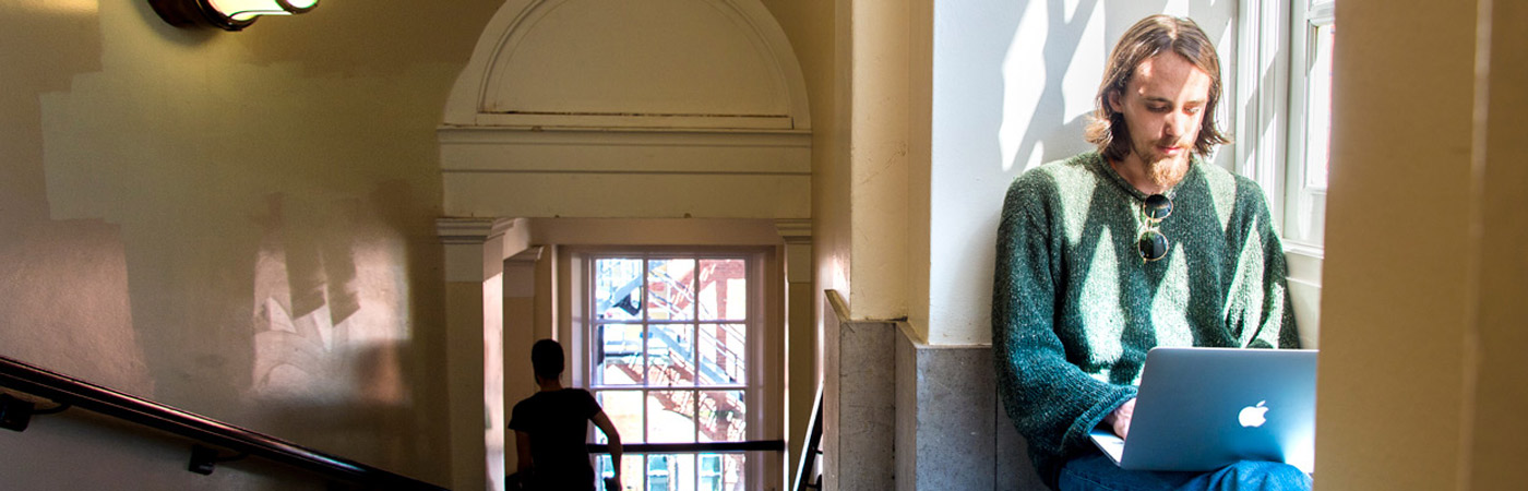 Student using laptop in the Samuel Alexander Building