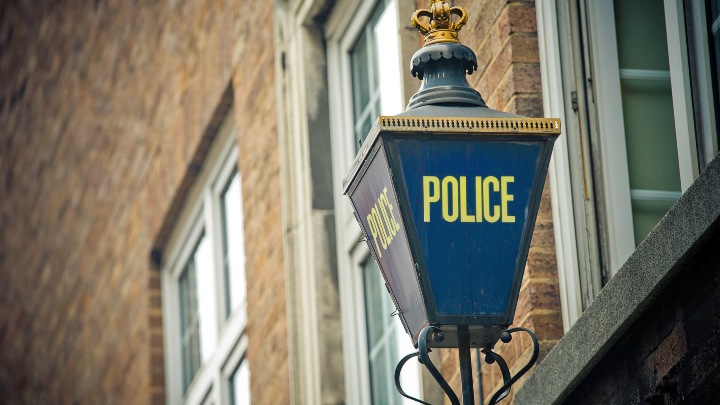 Police sign attached to building exterior