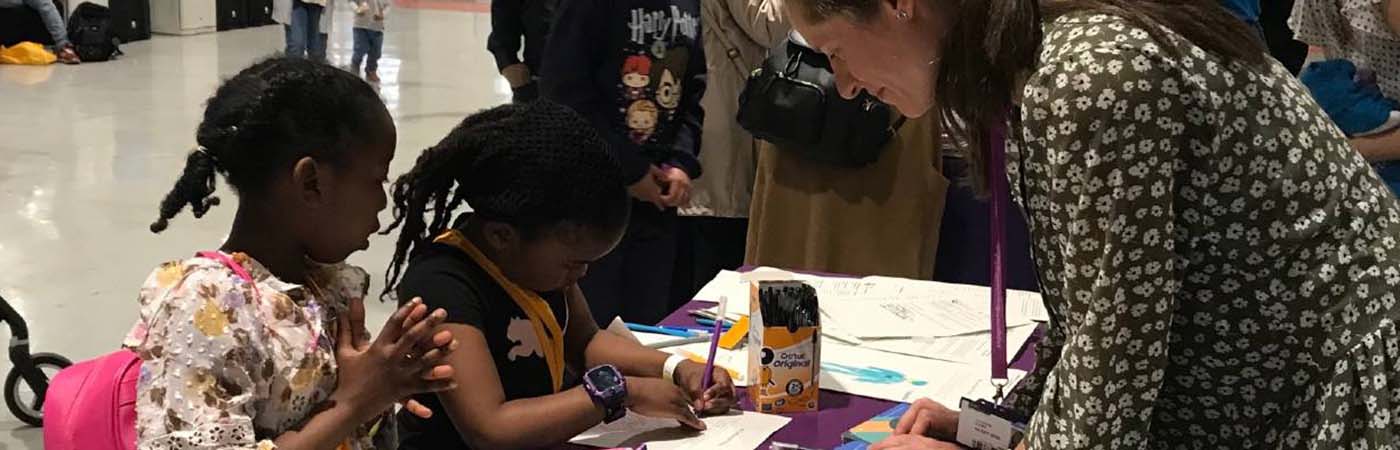 Female and children drawing pictures