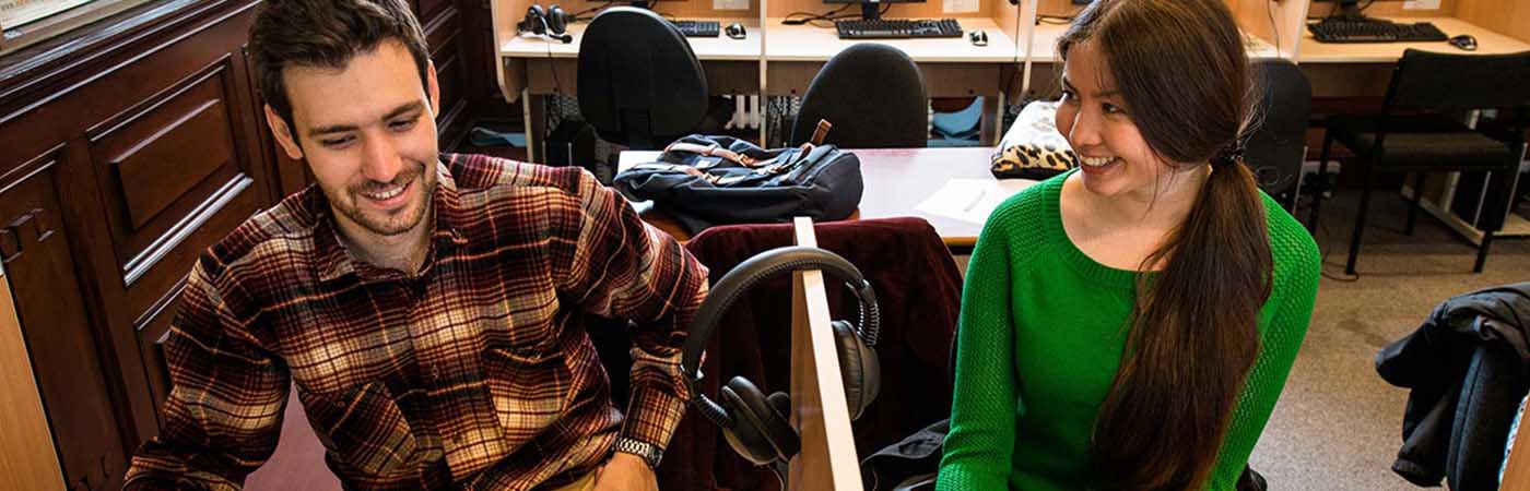Two students working in booths