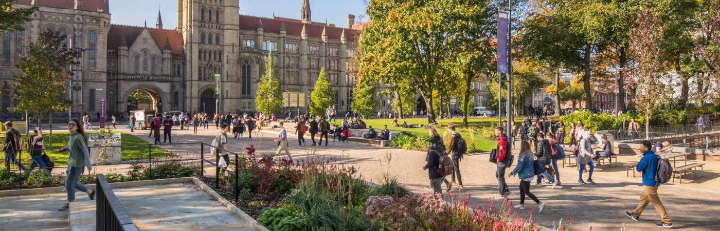 Students walking and cycling across campus 