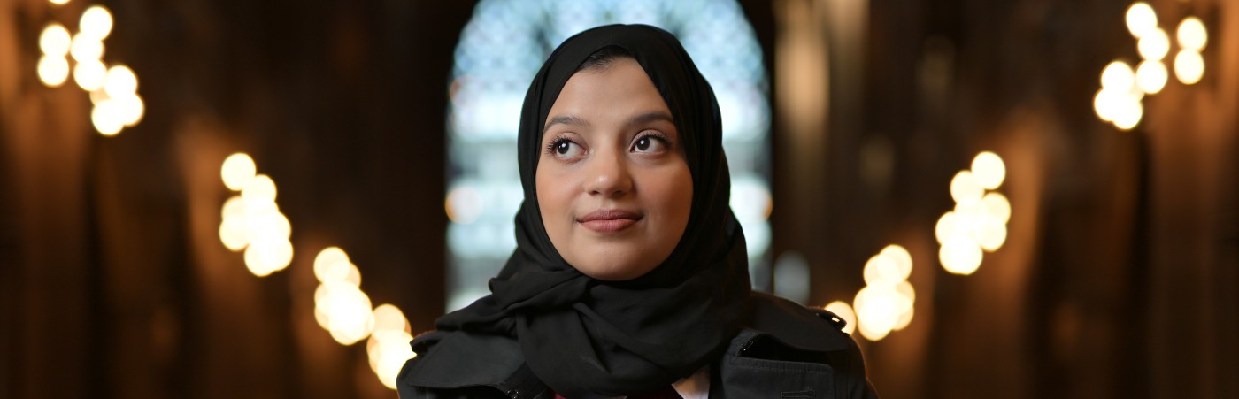 Student looking away in the distance with lighting behind them 