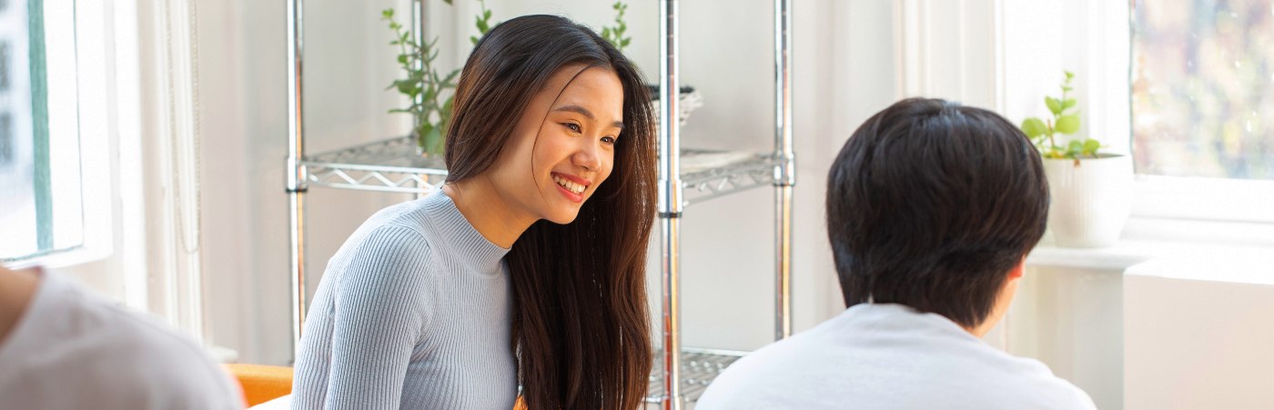 Student sat smiling with another student 