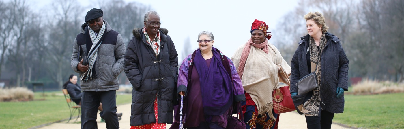 Diverse group of older people walking and smiling.