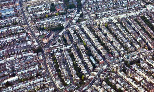 A helicopter view of a town's streets and houses
