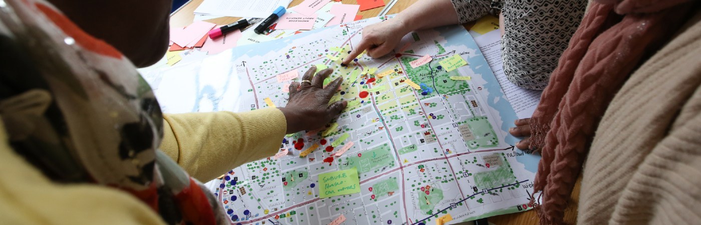 Hands pointing at a map of Manchester.