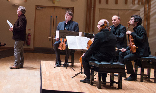 A string quartet sat on stage with their instruments
