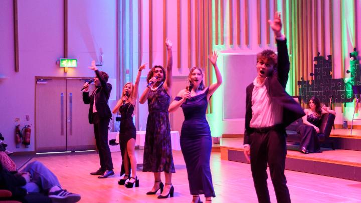 A group of students performing on stage.