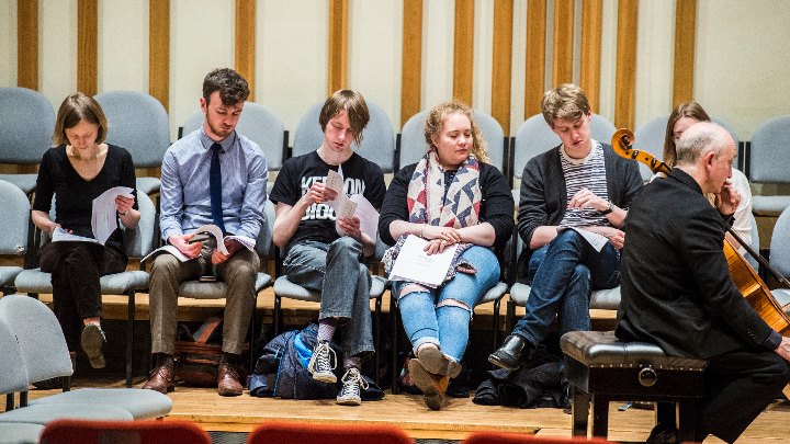 Students watching an experienced musician