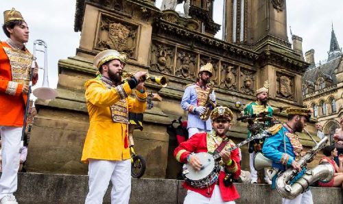 Band playing in front of a crowd in Manchester city centre.