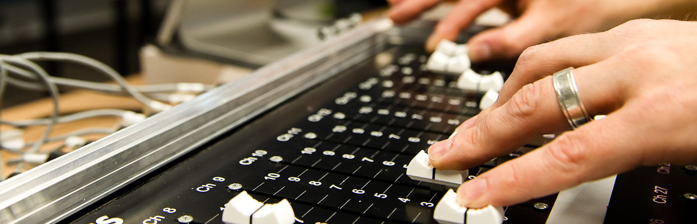 Researcher in music studio - close up of a mastering console.