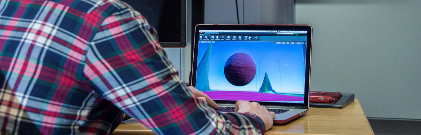 Postgraduate research student working on laptop