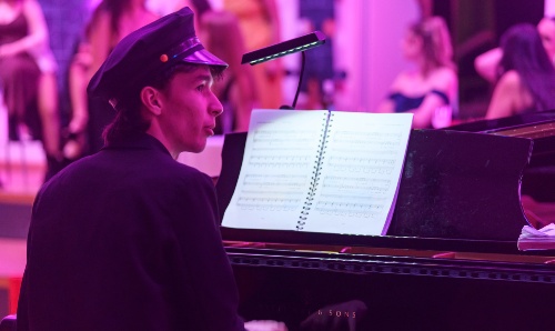 Male student playing piano.