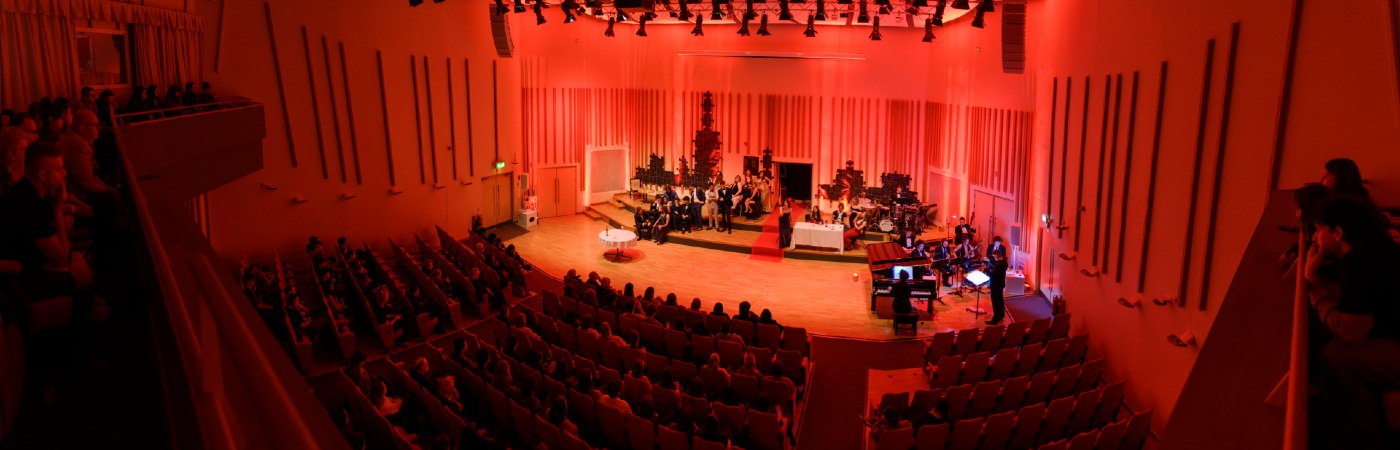 Student orchestra performing on stage.