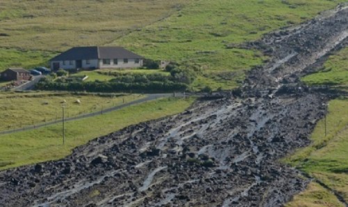 Hillside showing damage from flooding.