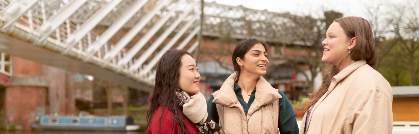 Three female University of Manchester students in Castlefield.