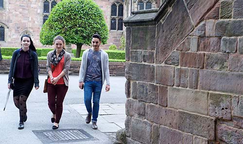 Politics students walking outside historic building