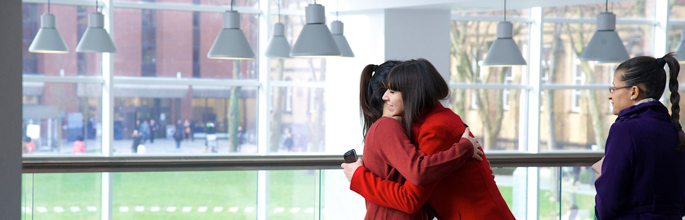 Two students hugging