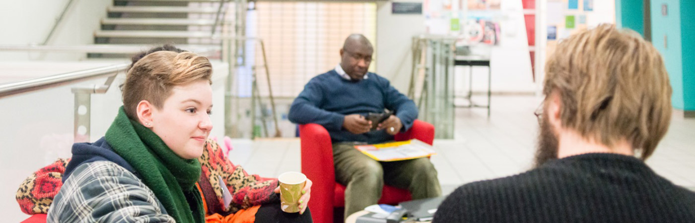 PhD student talking with supervisor in the Arthur Lewis Building.