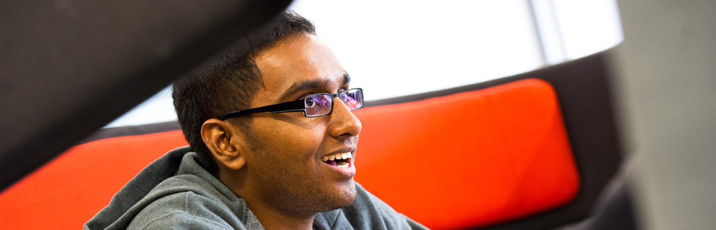 Smiling male student in study space