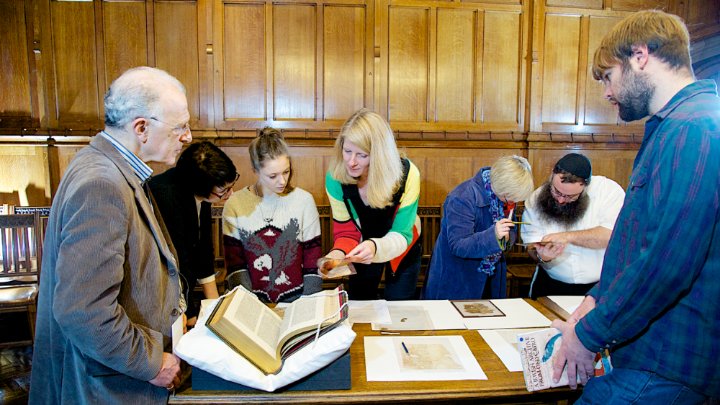 A group of people studying religious text.
