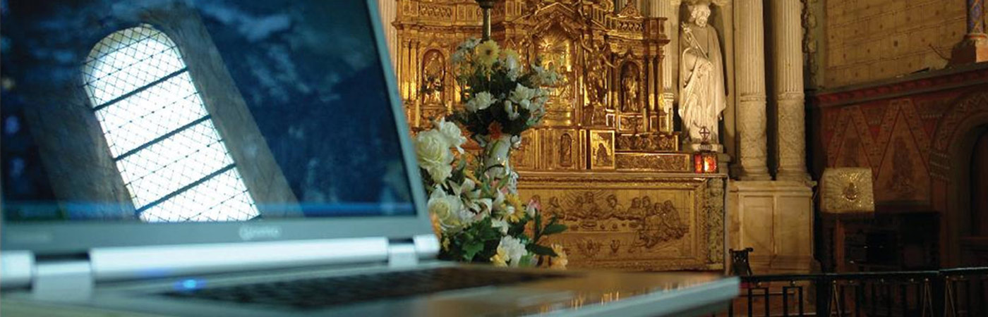 A laptop reflecting a church window in the screen