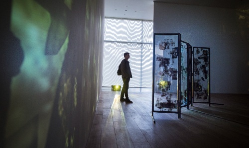 A man looking at an art piece at the Whitworth.